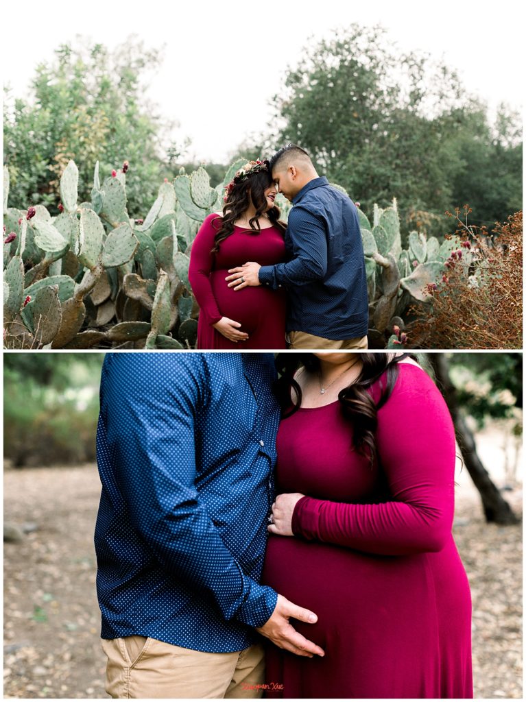 Two images stacked on top of each other of an interracial couple (an Asian male and a Latina female); they are touching foreheads with their eyes closed and both of them have their hands on her expectant belly in the first photo and the second photo is a close up show of just their torsos with their hands on moms expectant belly. He is wearing a dark blue button down with khakis and she is wearing a burgundy floor length dress.