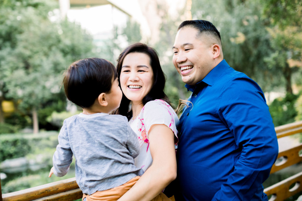 The Gomez family smiling and laughing during their family photography session in Pomona.