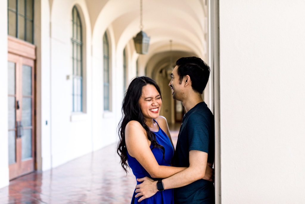 A couple laughing during their engagement photo session.