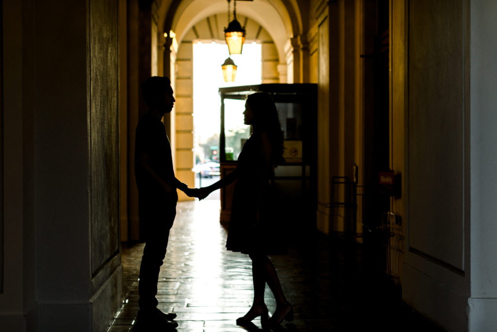 A couple looking at each other in a backlit photo in the hallways of Pasadena City Hall.