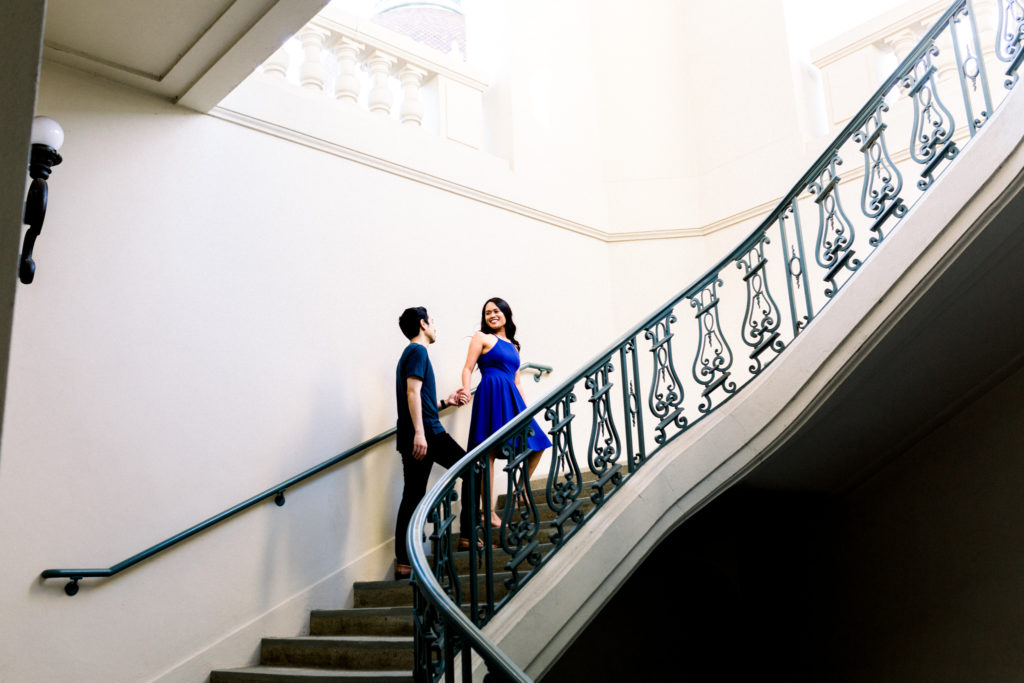A couple walking up the stairs of Pasadena City Hall during their engagement session.