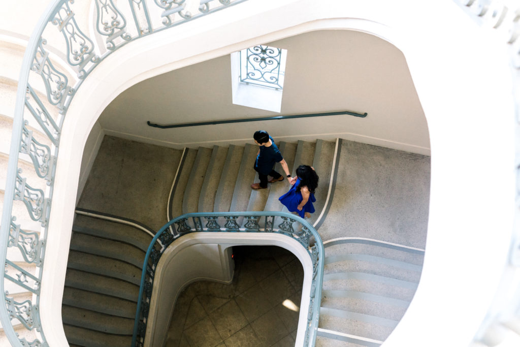 A couple walking down the stairs of Pasadena City Hall.