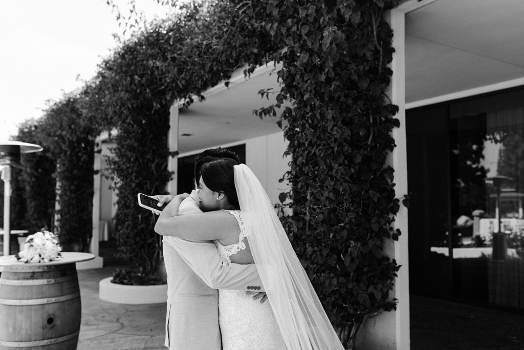 The bride and groom holding each other after a private vow exchange before their wedding.